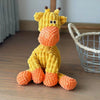 A yellow and orange crocheted plush toy shaped like a donkey for dogs