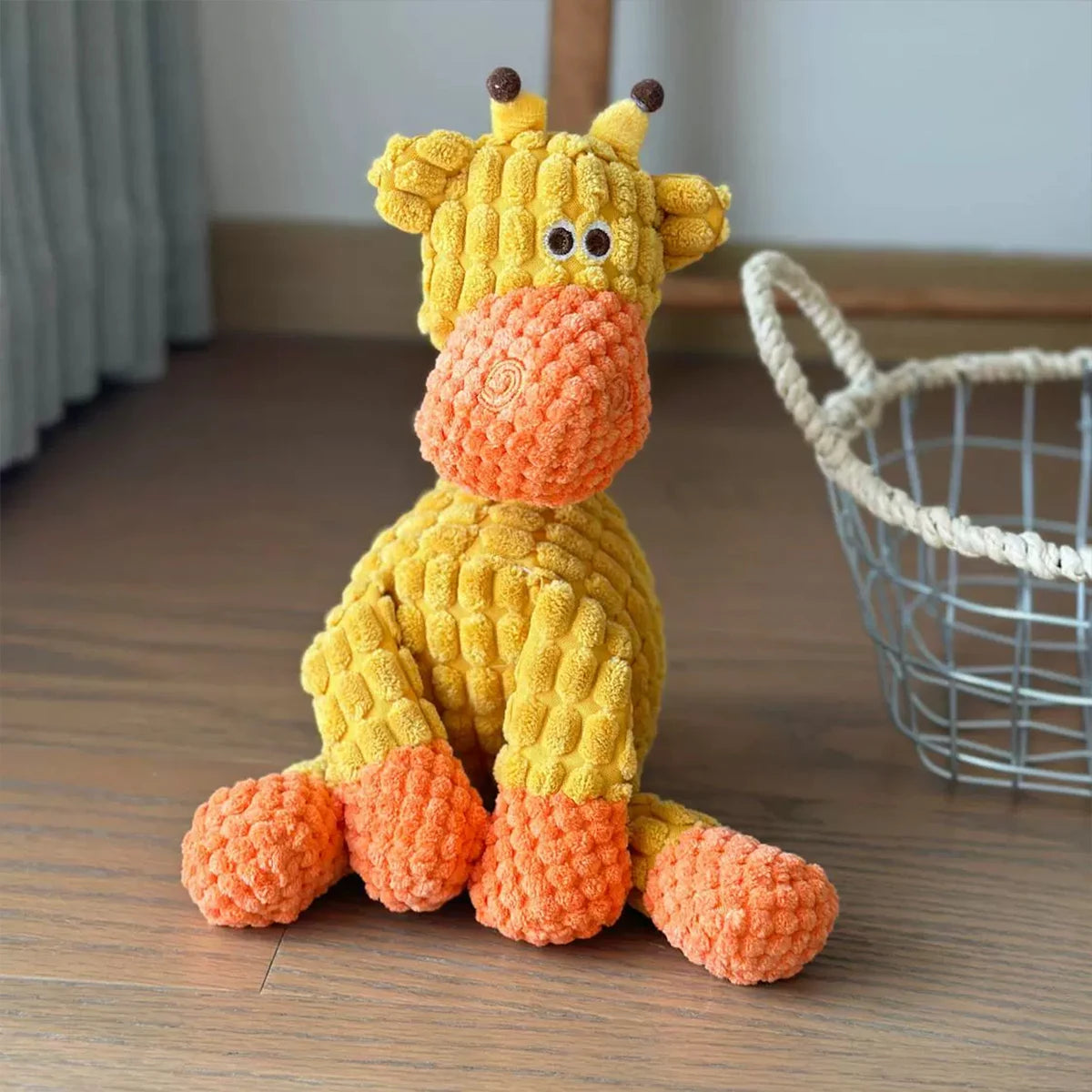 A yellow and orange crocheted plush toy shaped like a donkey for dogs