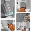 A white automatic pet feeder and water dispenser showing various features like water storage, grain dispensing, and a guardra