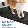 An orange and white cat is standing on a black, textured litter mat.