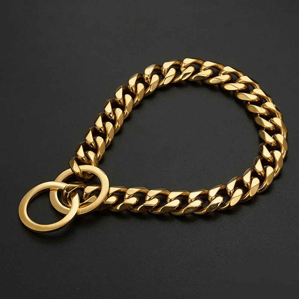 A gold stainless steel Cuban link training collar for a dog, shown against a dark background.