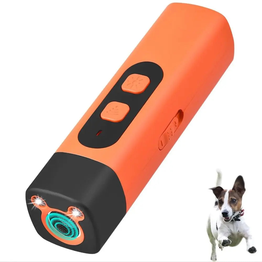 An orange and black ultrasonic dog bark deterrent trainer device with buttons and a dog nearby.