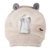 A beige knit ear muff for dogs with soft gray ears and a small brown paw print detail.