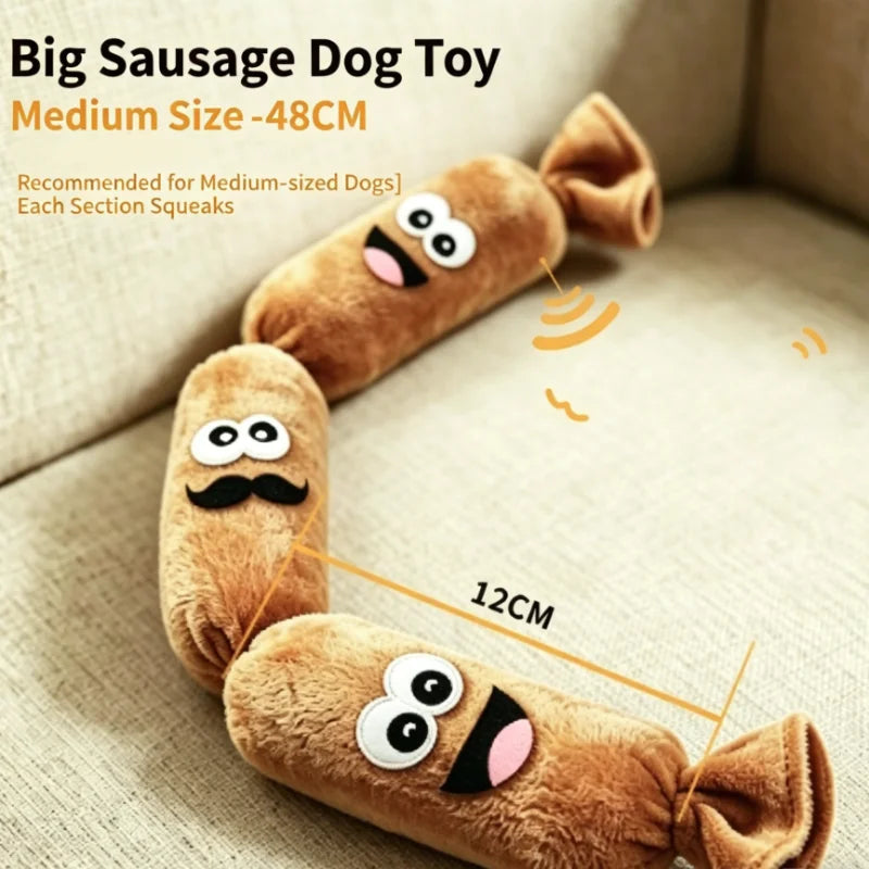 A brown plush sausage dog toy with a squeaker, shown lying on a light-colored fabric.