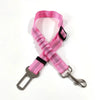 A bright pink reflective dog seat belt with an adjustable nylon harness shown against a white background.