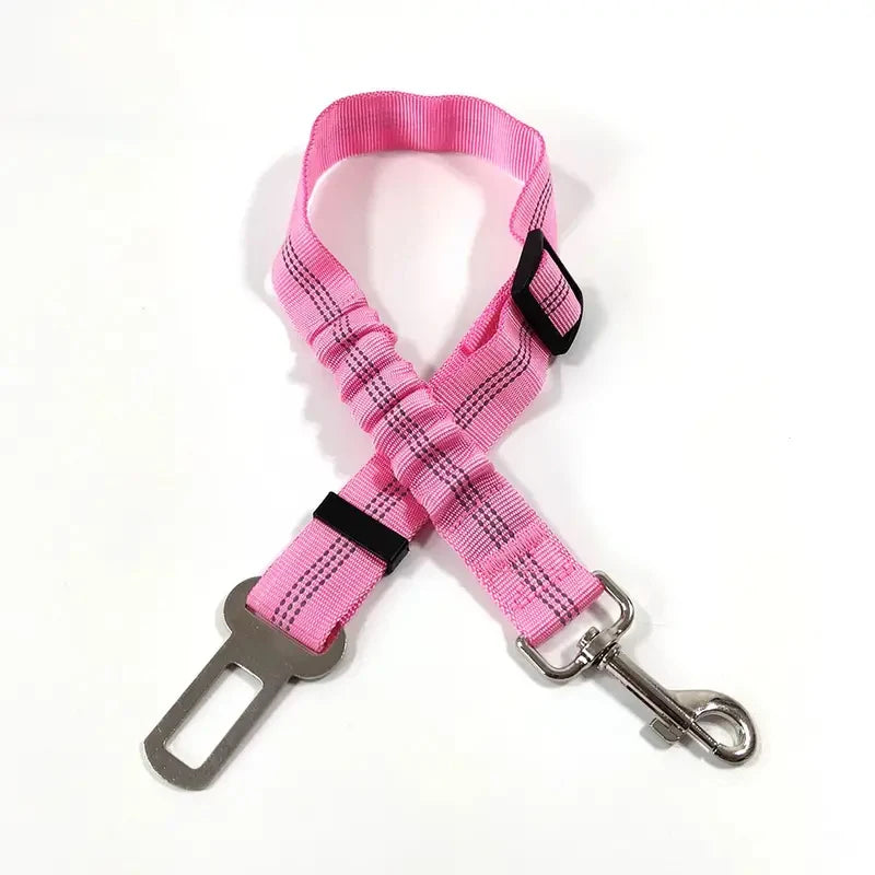 A bright pink reflective dog seat belt with an adjustable nylon harness shown against a white background.