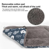 A portable elevated dog cot with a removable shade canopy featuring a soft, thick, gray faux fur mat and a patterned fabric i