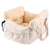 A beige pet car seat with a fluffy lining and safety straps is shown.