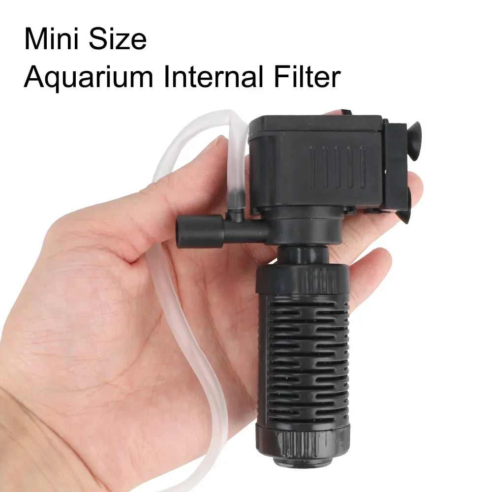A hand is holding a black mini size aquarium internal filter with a clear tubing.