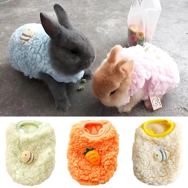 Three fluffy velvet pet sweaters in light blue, pink, and cream colors with small bee embroidery.