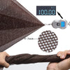 A close-up view of a dark brown safety net material being held, with a digital scale showing 100.00 kg.