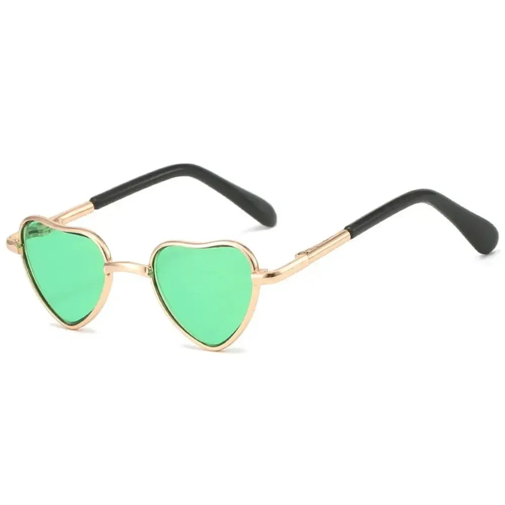 Funny heart-shaped pet sunglasses with green lenses and gold-toned frames