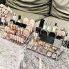Clear acrylic display stand filled with various cosmetic products and bottles on a marble surface