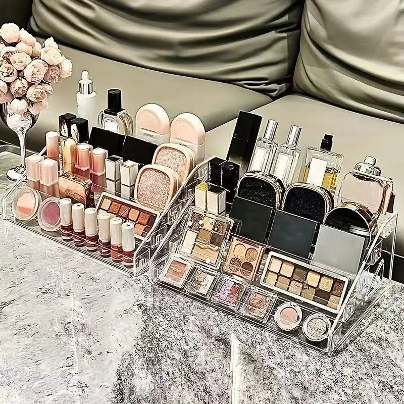 Clear acrylic display stand filled with various cosmetic products and bottles on a marble surface