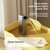 A stainless steel water fountain is shown pouring water into a yellow bowl, emphasizing clean water outlet and texture.