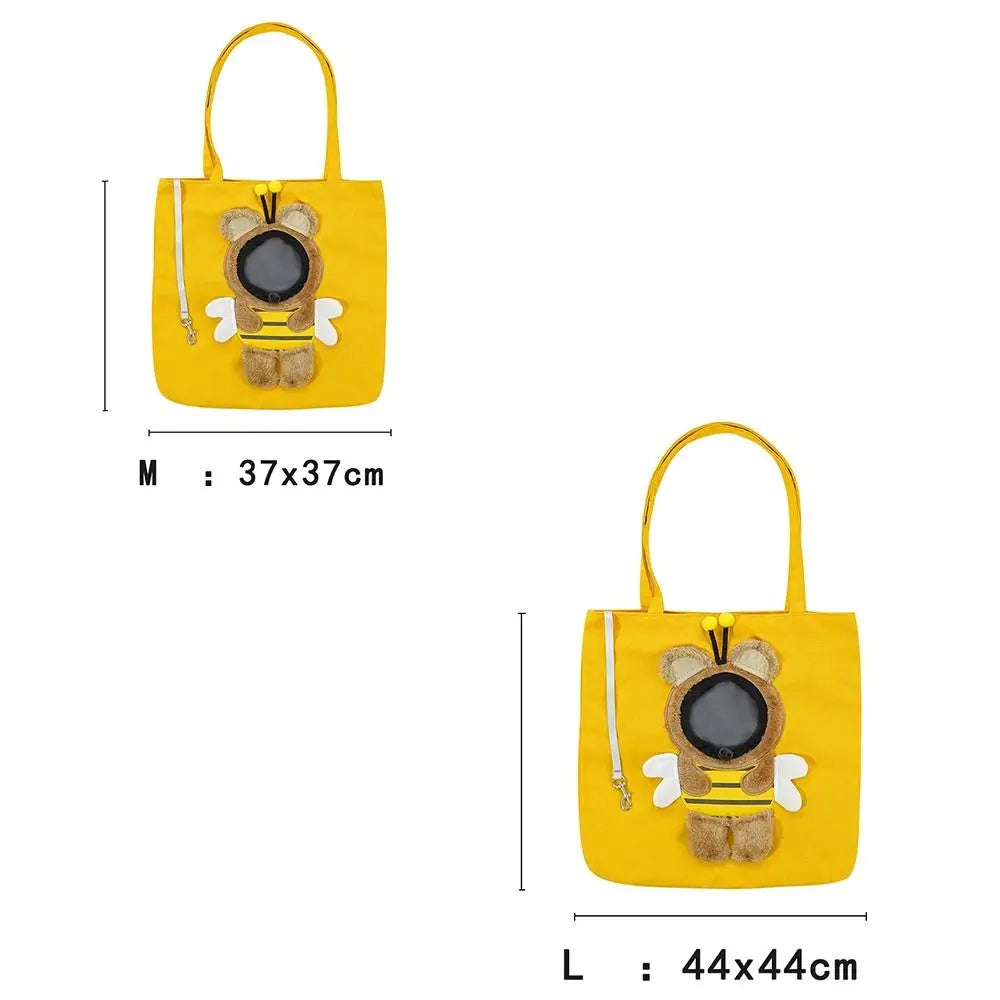 Yellow fabric pet carrier bag shaped like a bear with black eyes and yellow trim