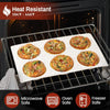 A white silicone baking tray holds several golden egg muffins in a black oven rack.