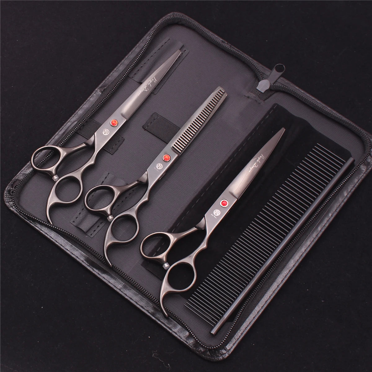 A black case holds a professional stainless steel pet grooming scissors set including various grooming tools.