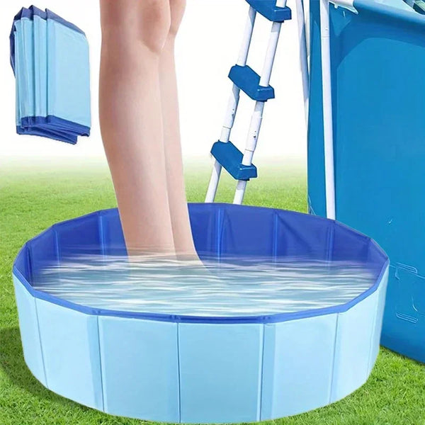 A blue foldable pet swimming pool filled with water, positioned on green grass next to a ladder.