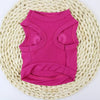 A bright pink princess crown puppy t-shirt laid on a cream woven mat.