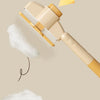 A beige pet brush with massage pins is shown, featuring a yellow arrow indicating direction and white fluff.