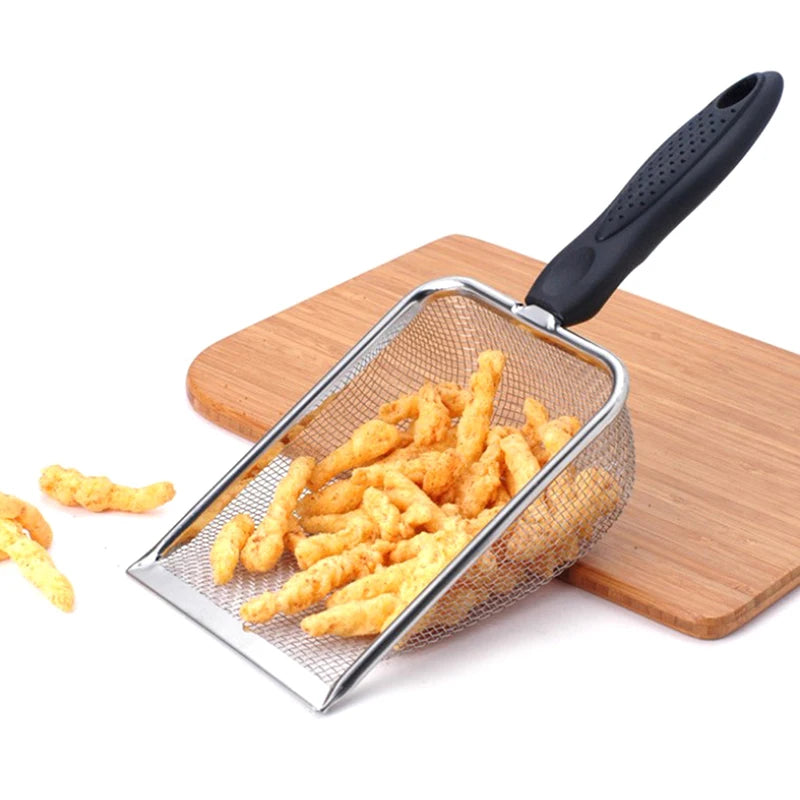 Stainless steel pet poop shovel with a long handle resting on a wooden board, containing yellow food pellets.
