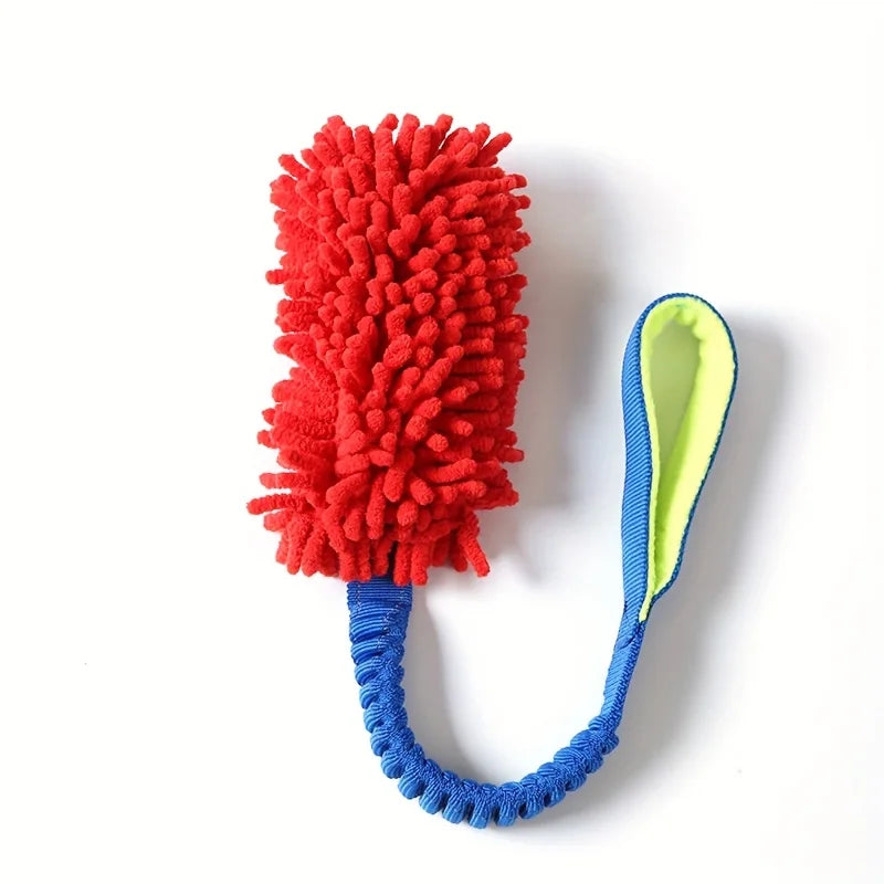 A bright red, fluffy plush pull rope toy with a blue cord and a light green handle.