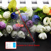A precision tool kit for handling small beads, showing a grid structure and various flower-like objects.