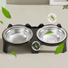 A black stainless steel double pet bowl with an anti-tip design, featuring green leaves.