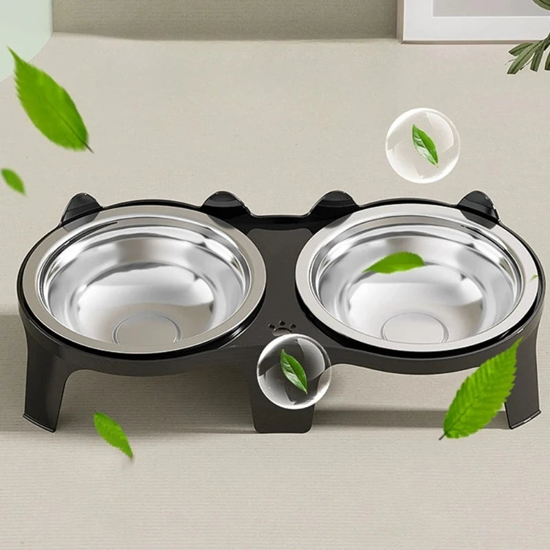 A black stainless steel double pet bowl with an anti-tip design, featuring green leaves.