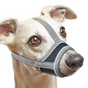 A light-colored dog wearing a gray adjustable reflective soft muzzle covering its nose and mouth.