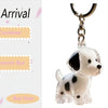 A clear, dog-shaped keychain featuring a white and black spotted design, attached to a silver chain.