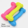 A set of three pink, yellow, and blue squeaky chew toys shaped like the number 7 for dog training
