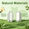 Two white natural material scent deodorizers are shown on green grass with a cat in the background.