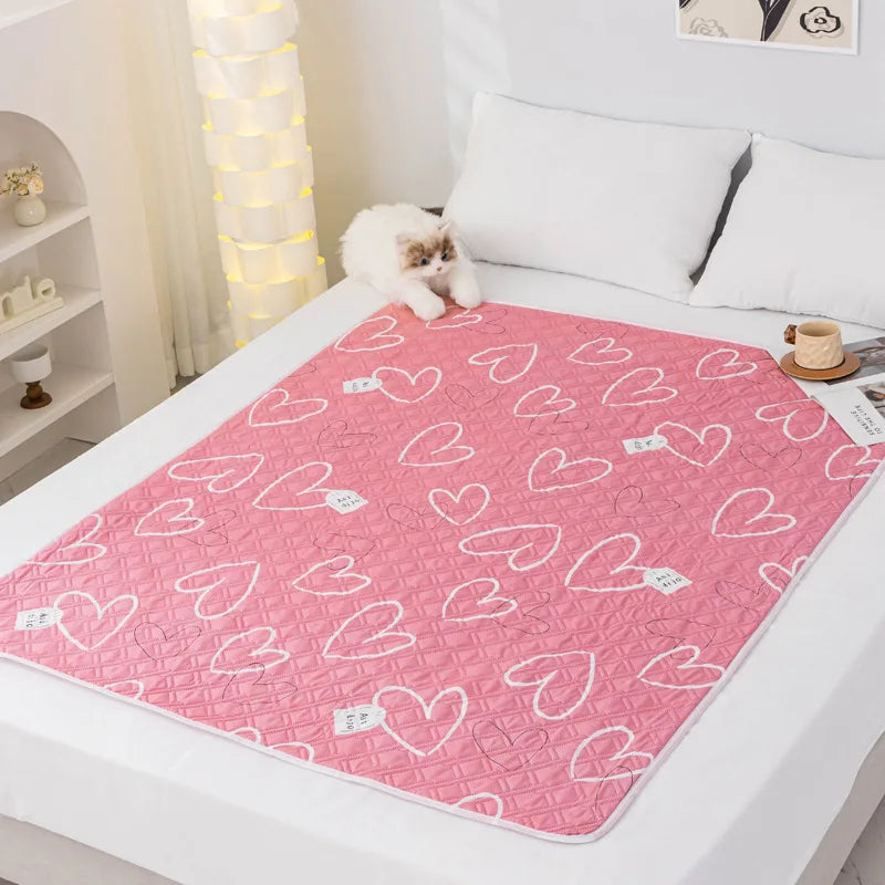 Pink heart pattern reusable absorbent pet pee pads placed on a white surface.