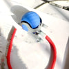 A blue spherical training ball with a white base and red cord is shown on a sheet of paper.