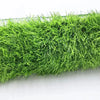 A dense mat of bright green artificial grass used for dog training.