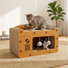 A wooden cat scratcher house and lounge bed with a cat sitting on top and another cat inside.