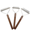 A set of double-sided dog grooming combs and brushes with metal teeth and wooden handles.
