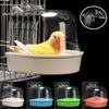 Clear plastic hanging bird bath with a yellow parakeet inside, shown in various colors.