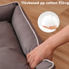 A hand is touching a gray orthopedic dog bed filled with thickened pp cotton, showing the soft filling.