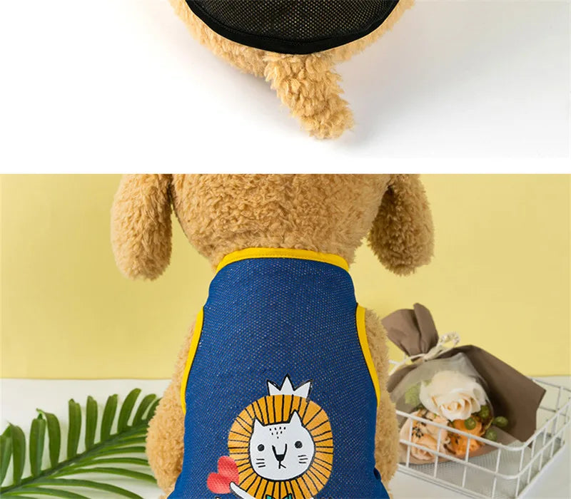 A fluffy yellow dog wearing a blue mesh summer vest with a cartoon lion print.