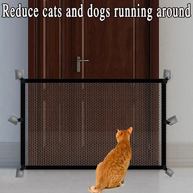 A folding pet safety fence with adhesive hooks is installed on a door, with an orange cat visible through the mesh.