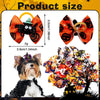 Halloween pumpkin print dog hair bows with rubber bands displayed on a dog and surrounding foliage