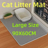 A large gray cat litter mat with a removable tray is shown on a wooden floor.