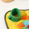 A bright yellow and orange snuffle mat with green fabric pieces for a dog toy.