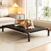 A golden retriever lies on a black mesh pet bed indoors next to a window.