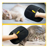 A pair of black double-sided pet grooming gloves being used on a kitten and a tabby cat.