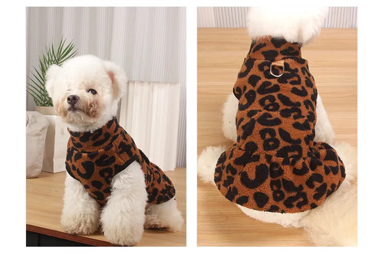 A fluffy white dog wearing a leopard print princess dress on its back.