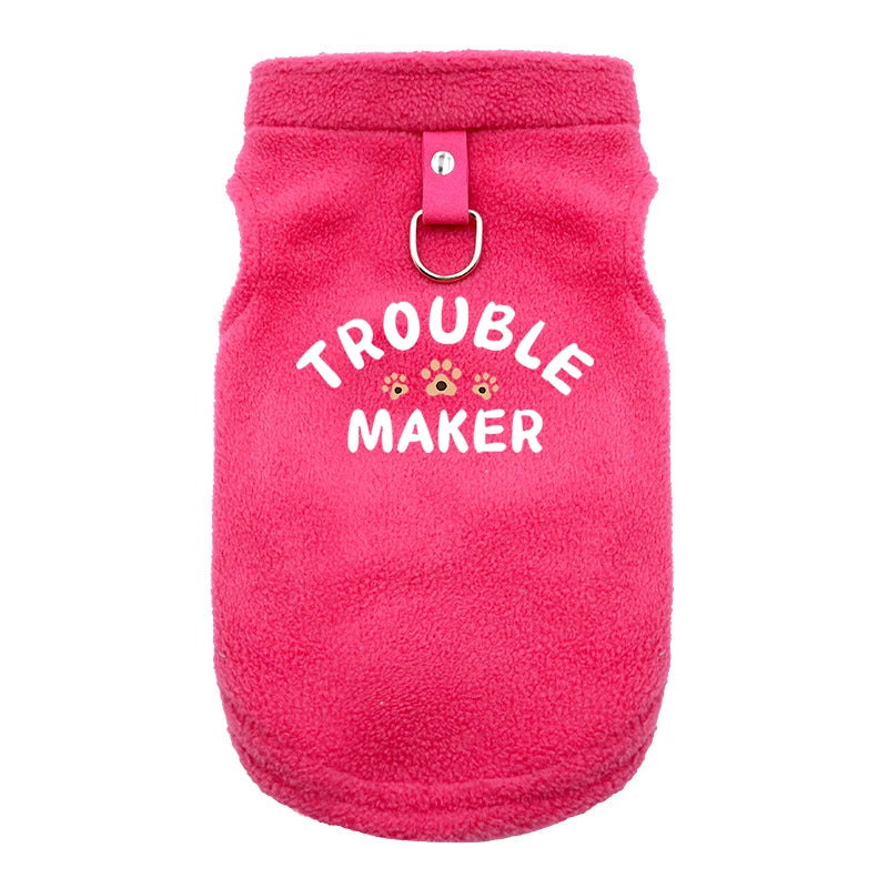 A bright pink, fuzzy pet jacket for dogs with a silver ring closure.